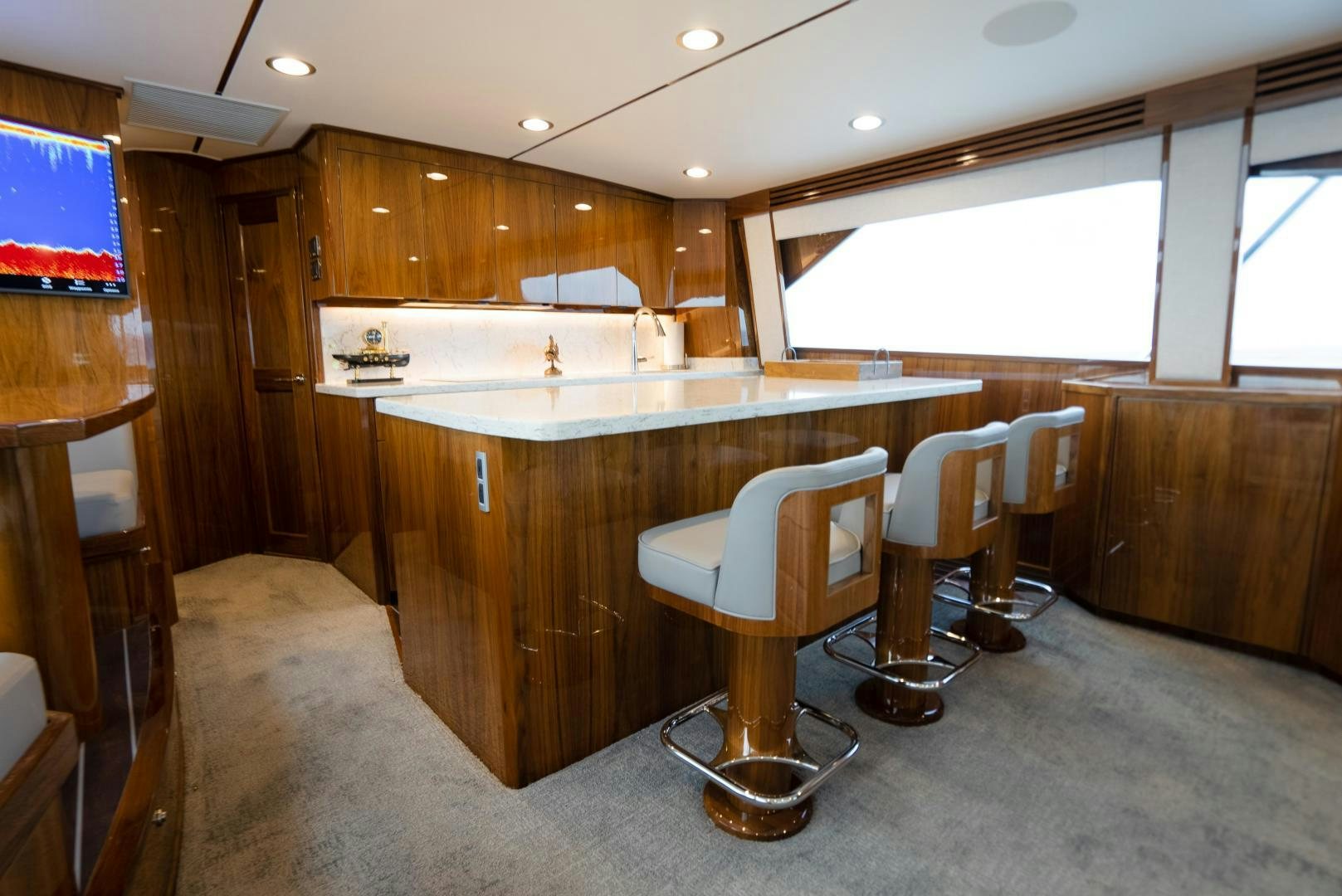 a kitchen with a bar and stools aboard DAWG DAZE Yacht for Sale