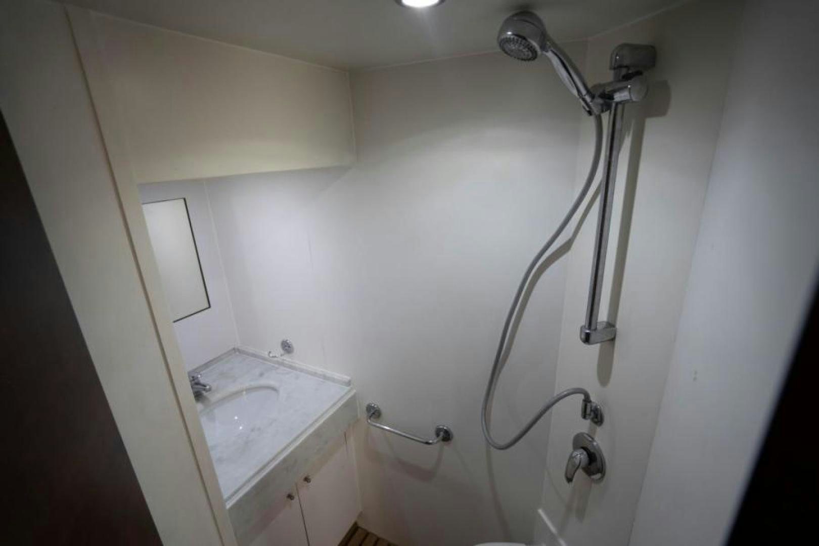a bathroom with a shower and sink aboard KNOT WOKE Yacht for Sale