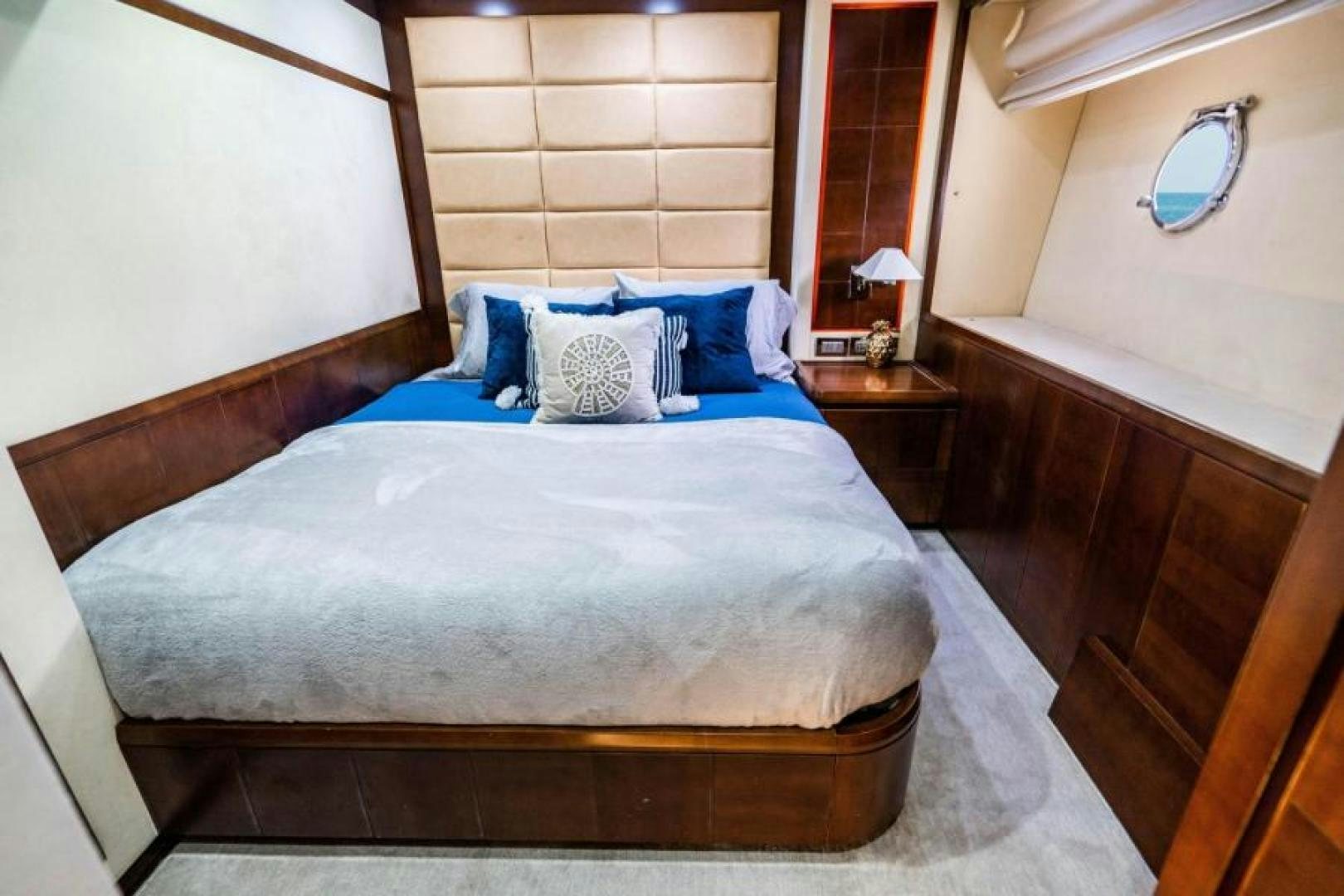 a bed with blue sheets aboard KNOT WOKE Yacht for Sale