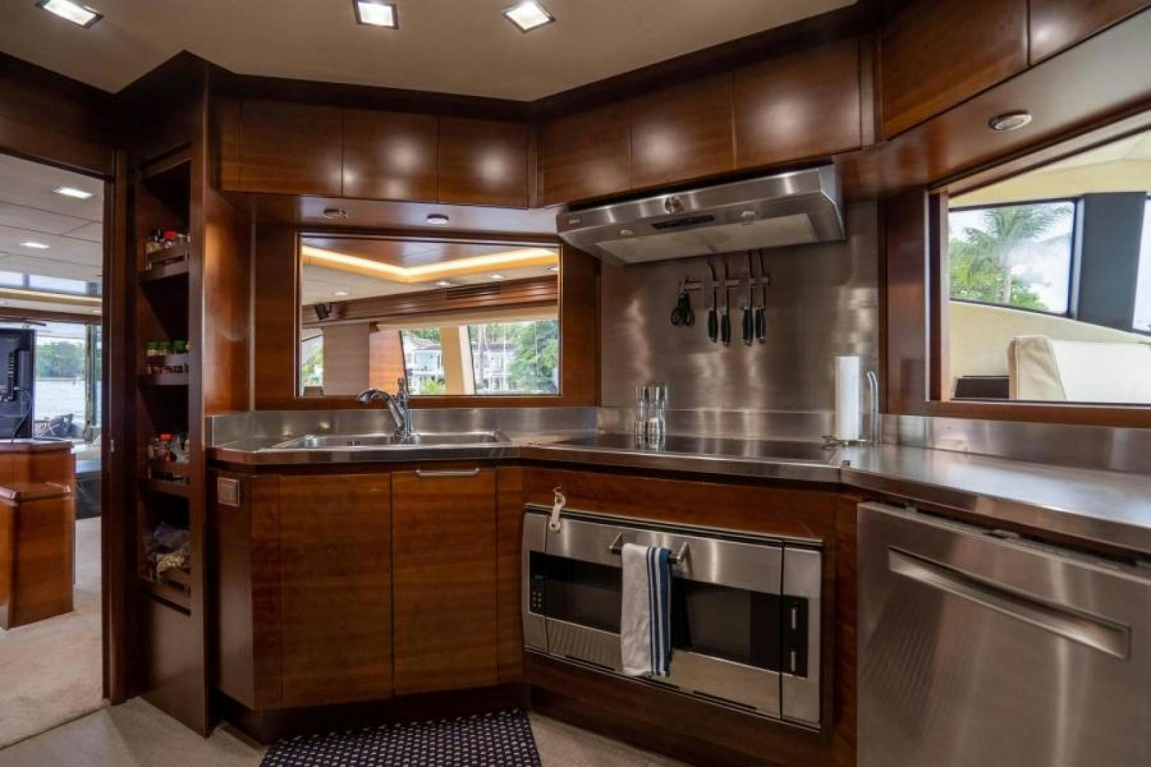 a kitchen with wooden cabinets aboard KNOT WOKE Yacht for Sale