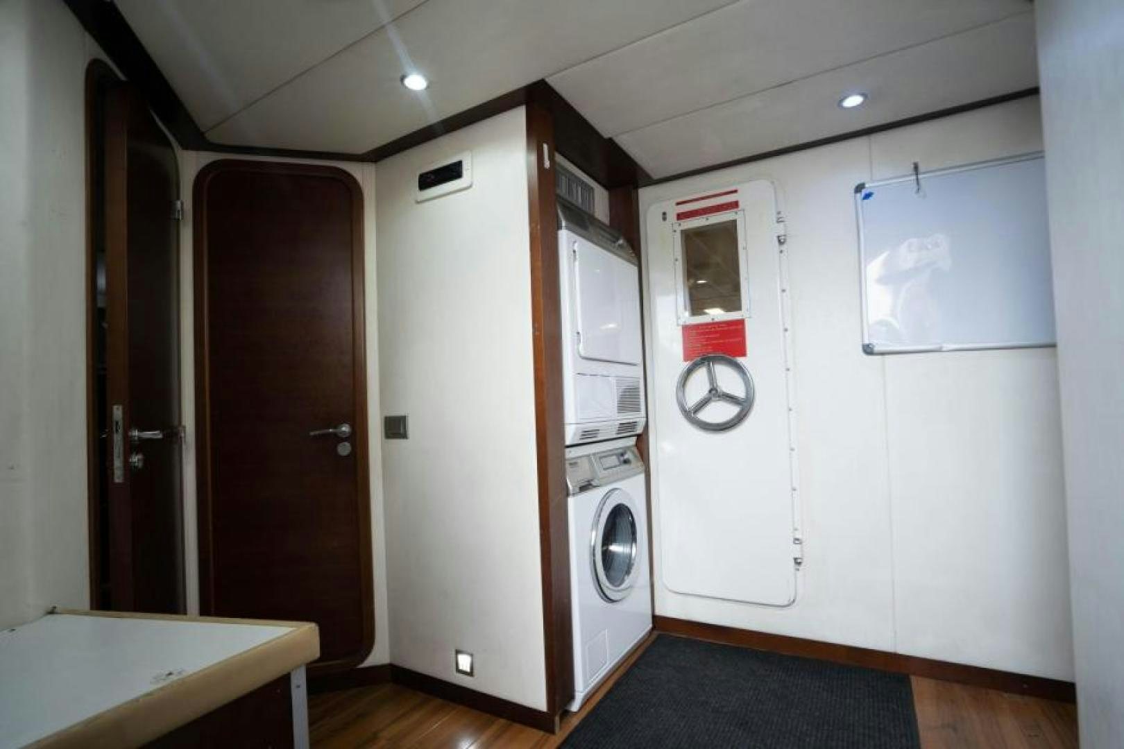 a room with a washing machine and dryer aboard KNOT WOKE Yacht for Sale