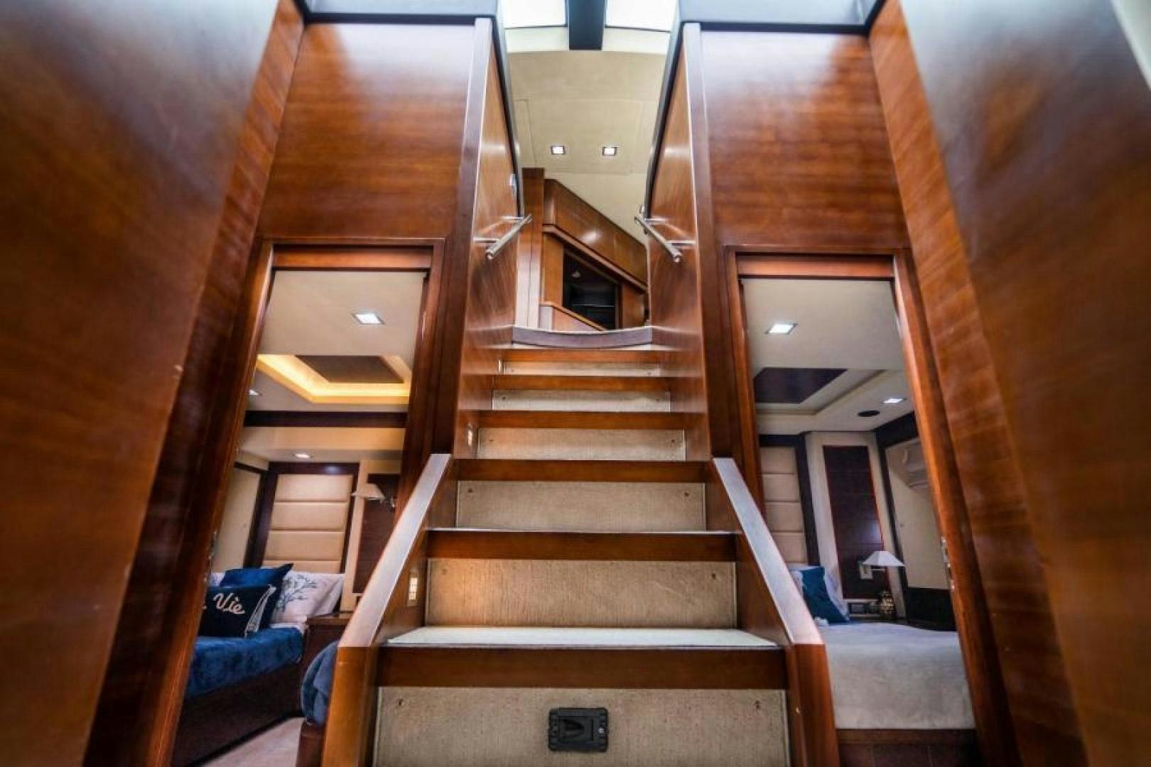 a wooden staircase with a window aboard KNOT WOKE Yacht for Sale