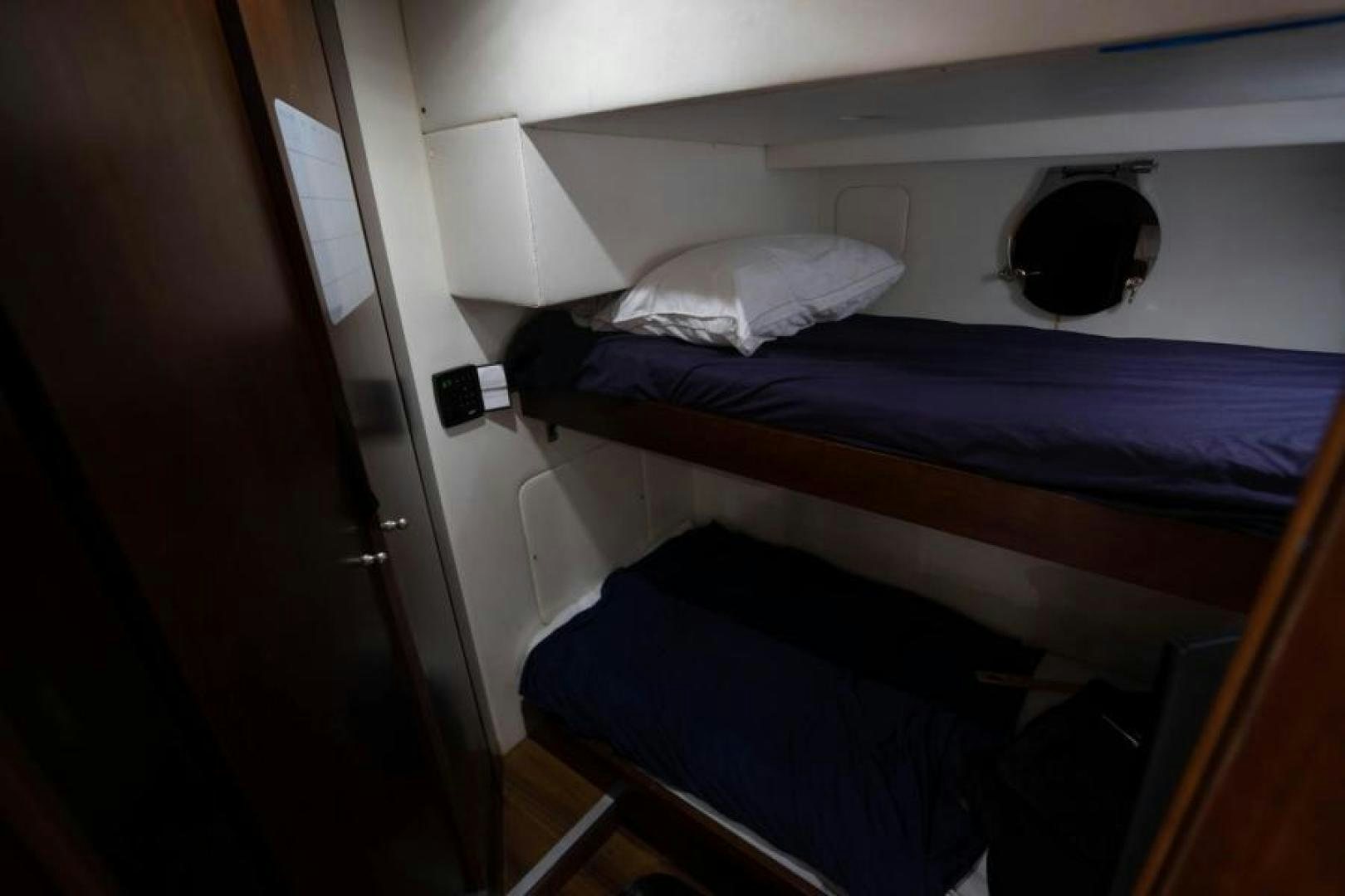 a bed with a black pillow aboard KNOT WOKE Yacht for Sale