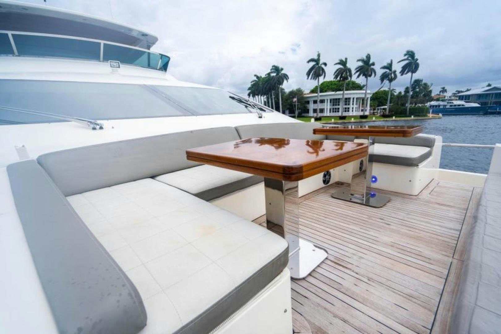 a deck with a table and chairs on it aboard KNOT WOKE Yacht for Sale