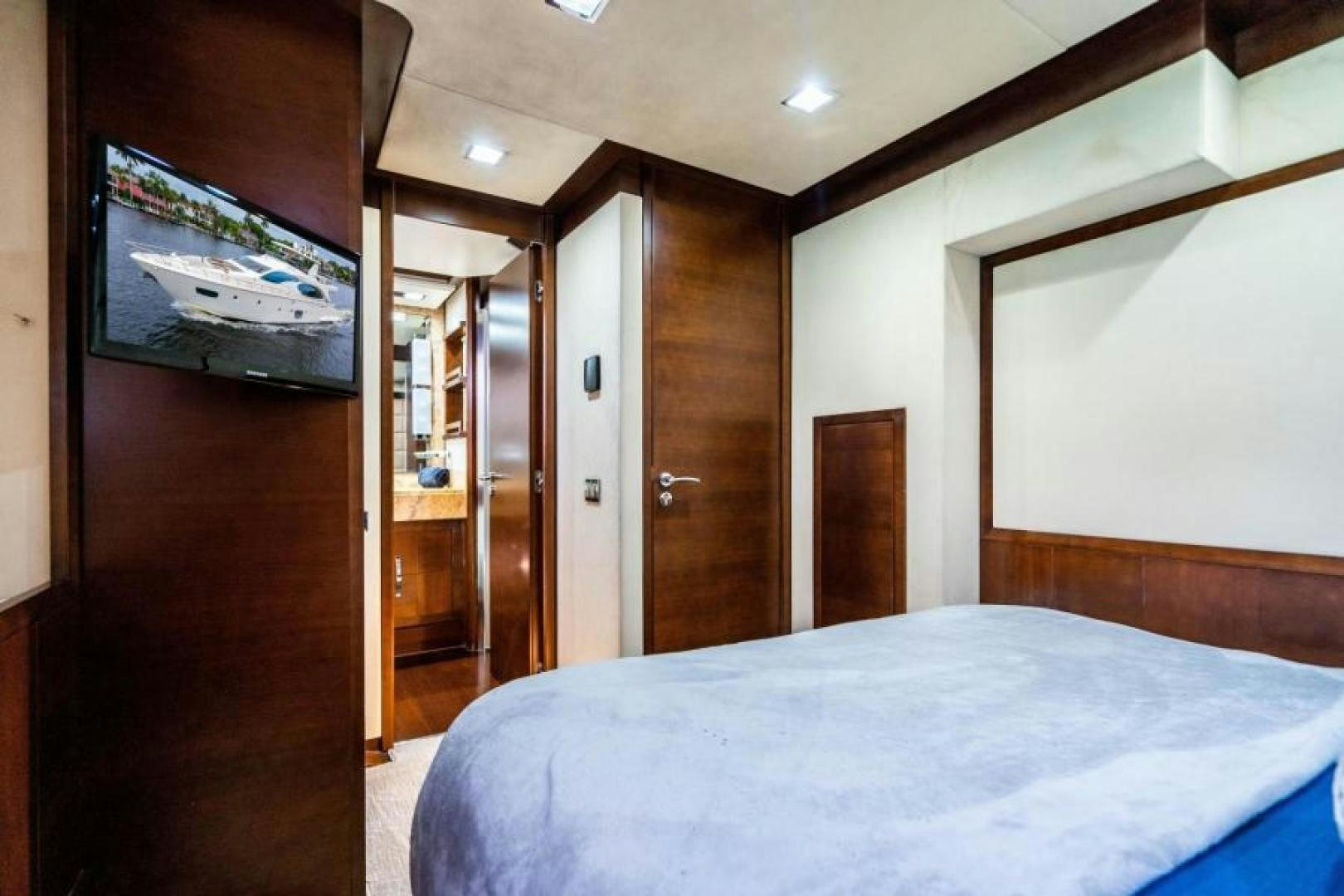 a bedroom with a bed and a television aboard KNOT WOKE Yacht for Sale