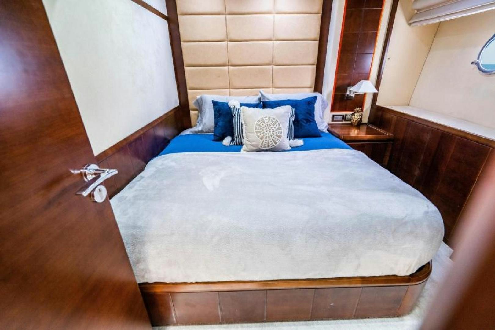 a bed with blue sheets aboard KNOT WOKE Yacht for Sale