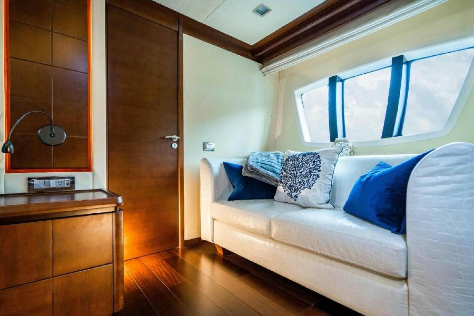 a living room with a couch and a wood door aboard KNOT WOKE Yacht for Sale