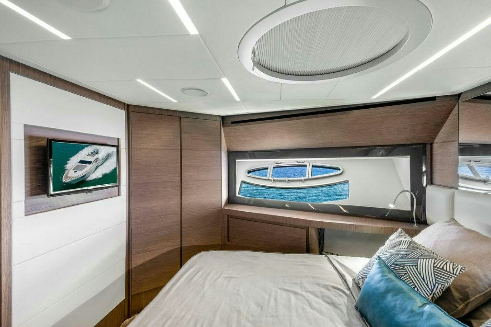 a room with a bed and a television aboard VIDI Yacht for Sale
