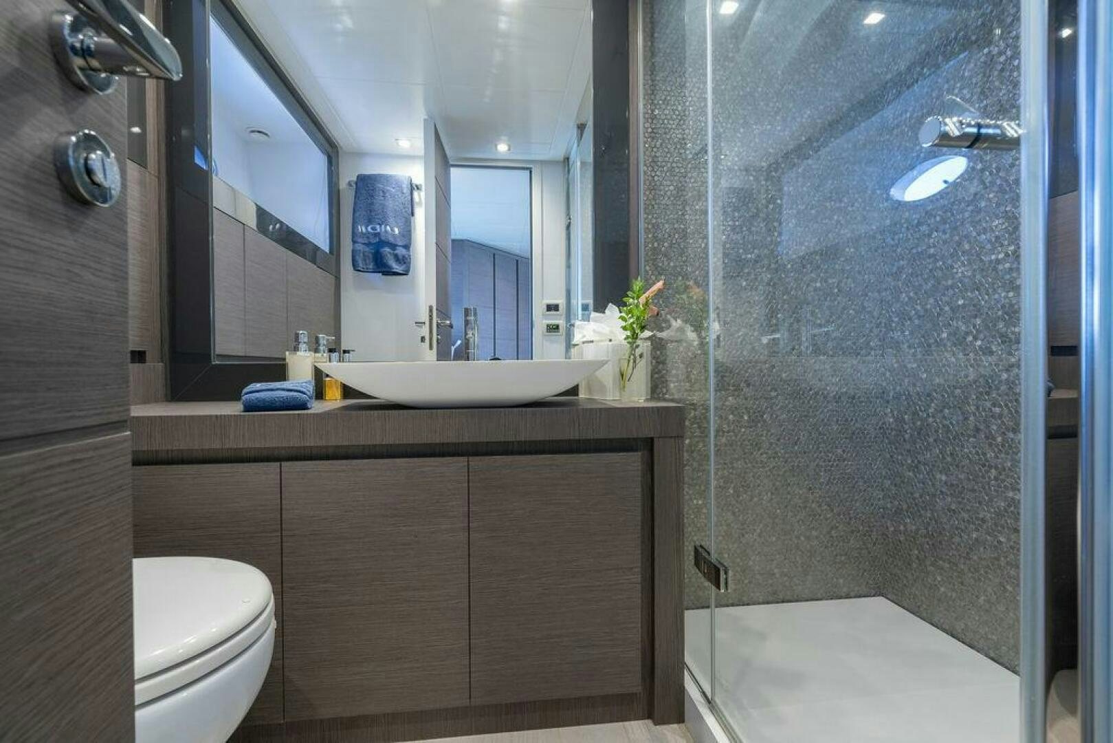 a bathroom with a glass shower aboard VIDI Yacht for Sale
