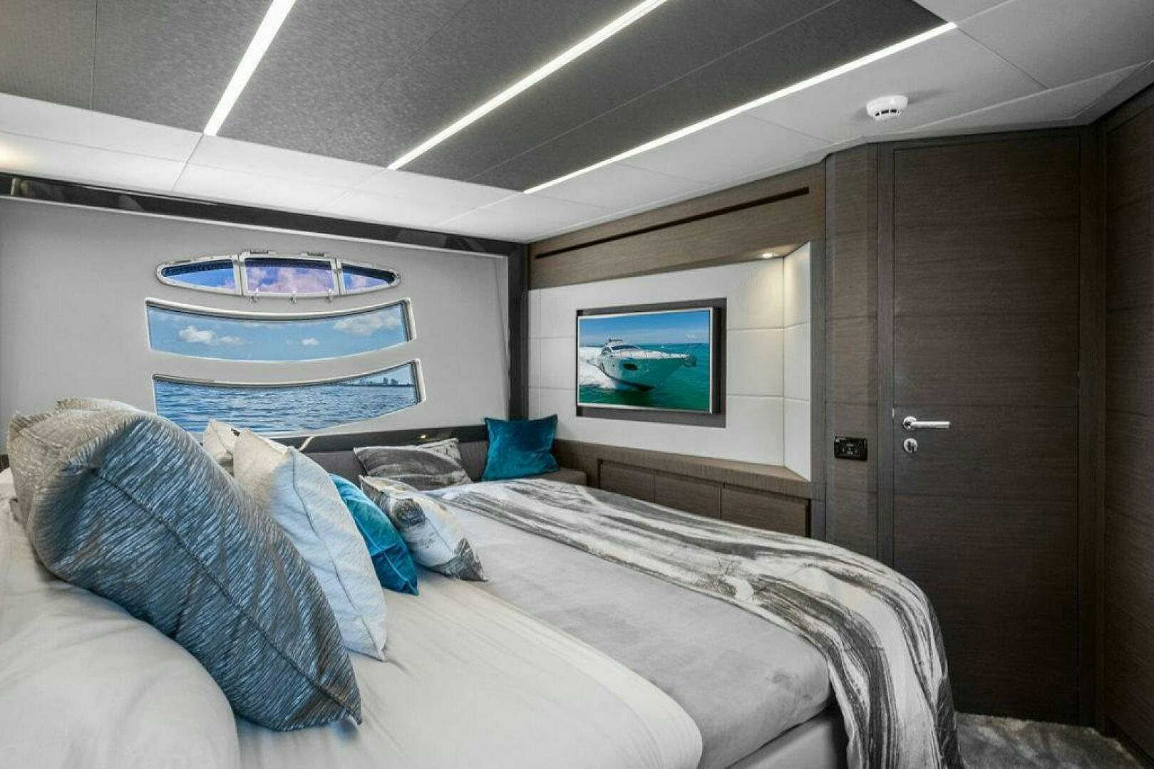 a room with a bed and a television aboard VIDI Yacht for Sale
