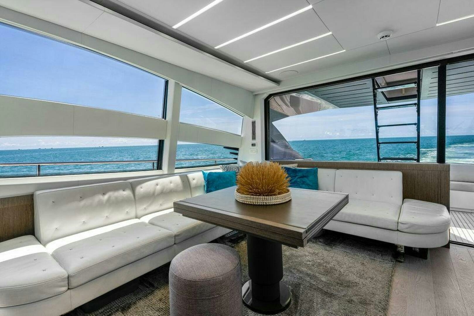 a room with a couch and a table and a window aboard VIDI Yacht for Sale