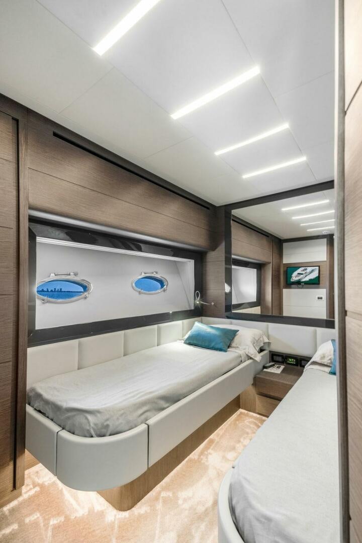 a room with a bed and a television aboard VIDI Yacht for Sale