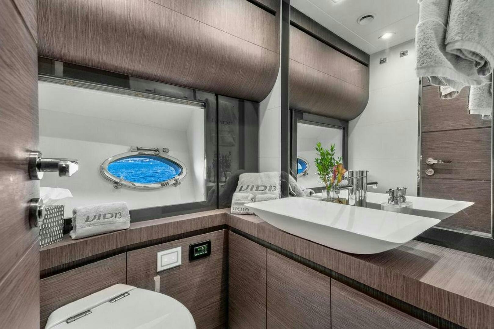 a bathroom with a large mirror aboard VIDI Yacht for Sale