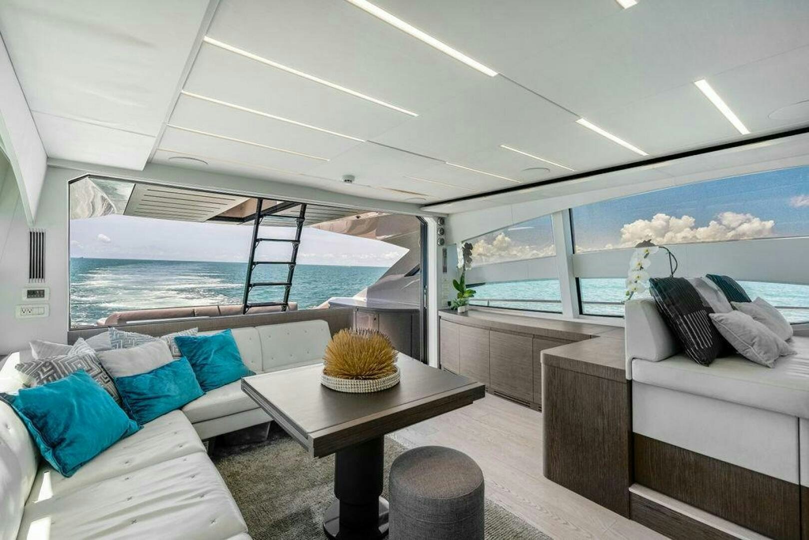 a room with a table and couches aboard VIDI Yacht for Sale