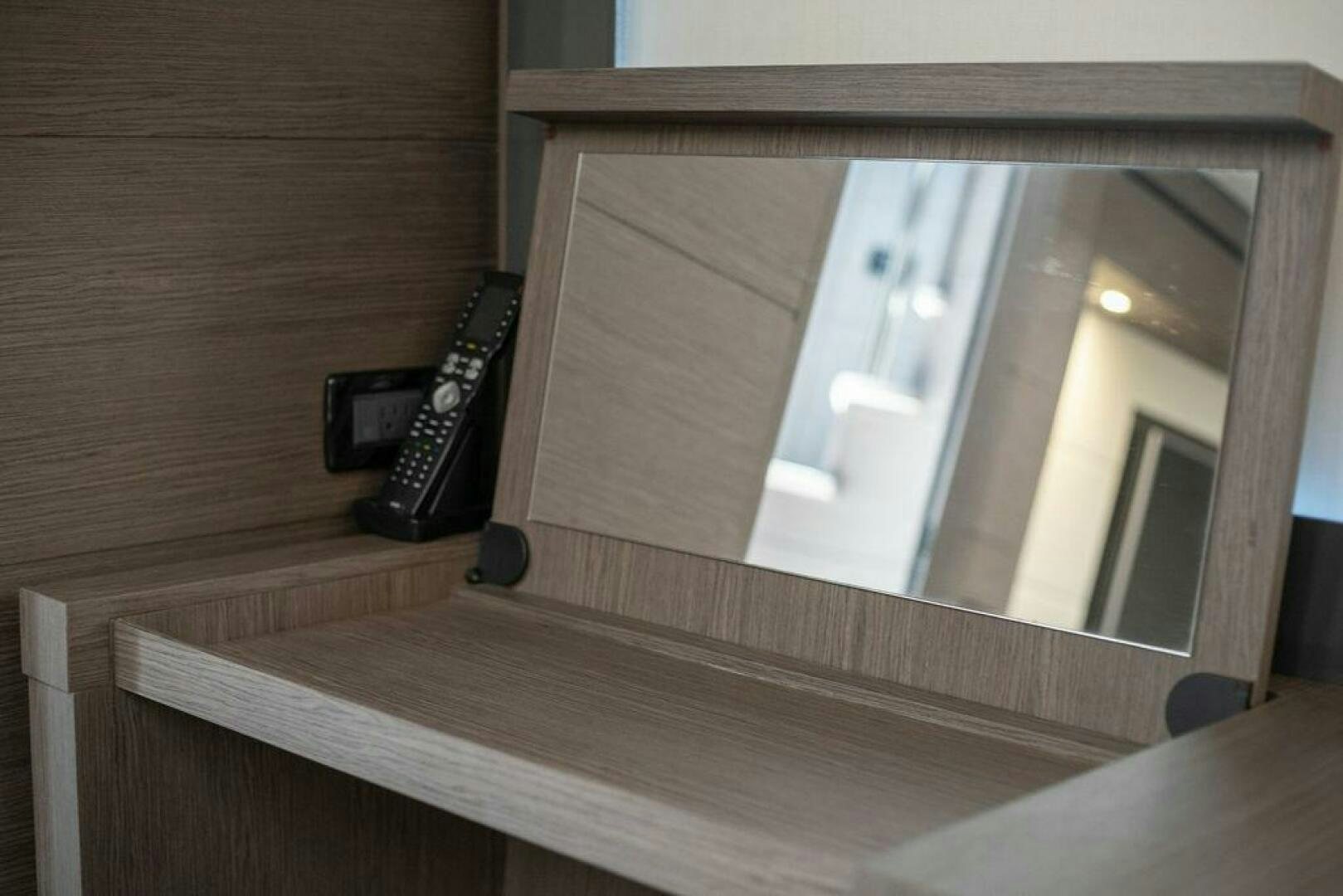 a phone on a wood shelf aboard VIDI Yacht for Sale