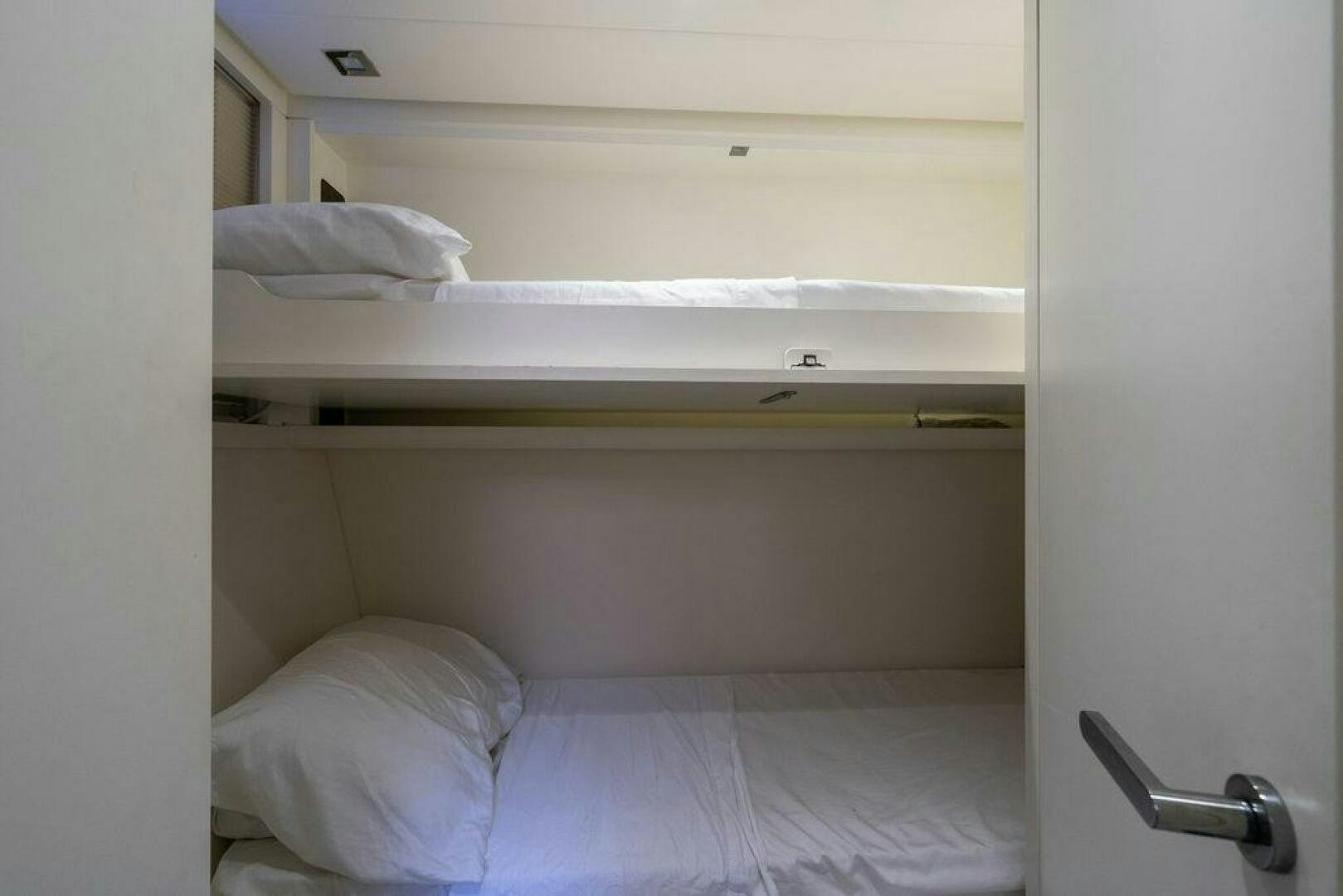 a closet with white sheets aboard VIDI Yacht for Sale