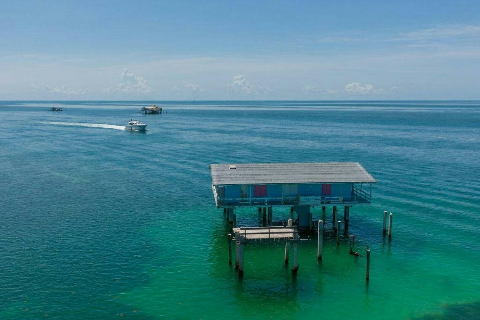 a house on a dock in the ocean aboard VIDI Yacht for Sale