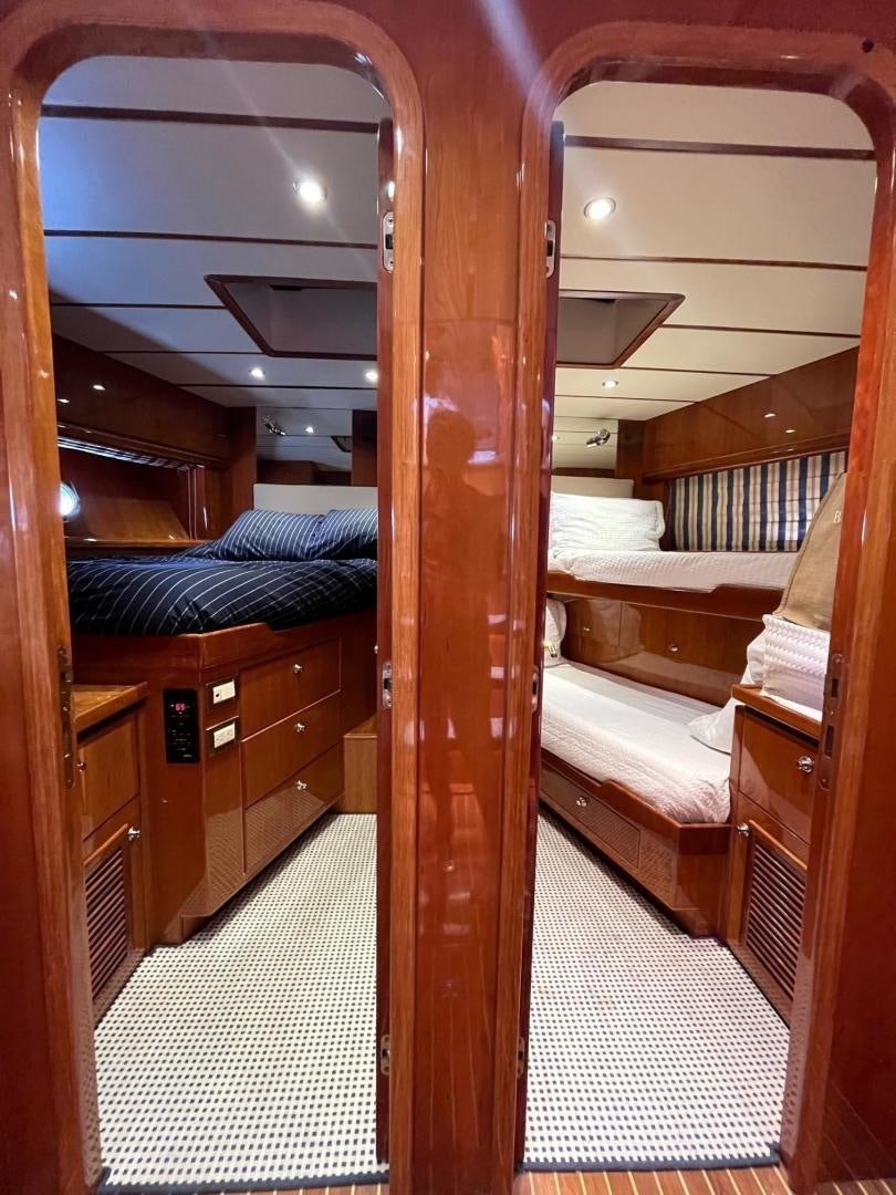 a room with a bed and a wood door aboard GRACE Yacht for Sale