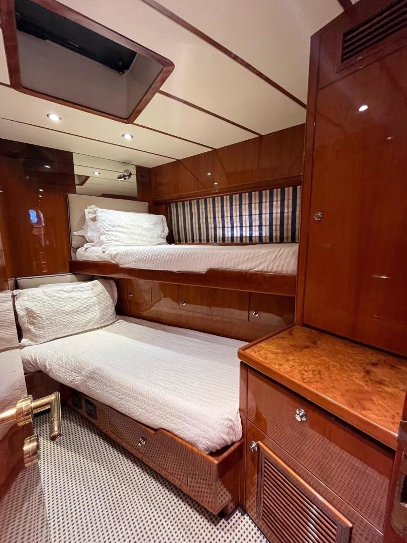 a room with a bed and a dresser aboard GRACE Yacht for Sale