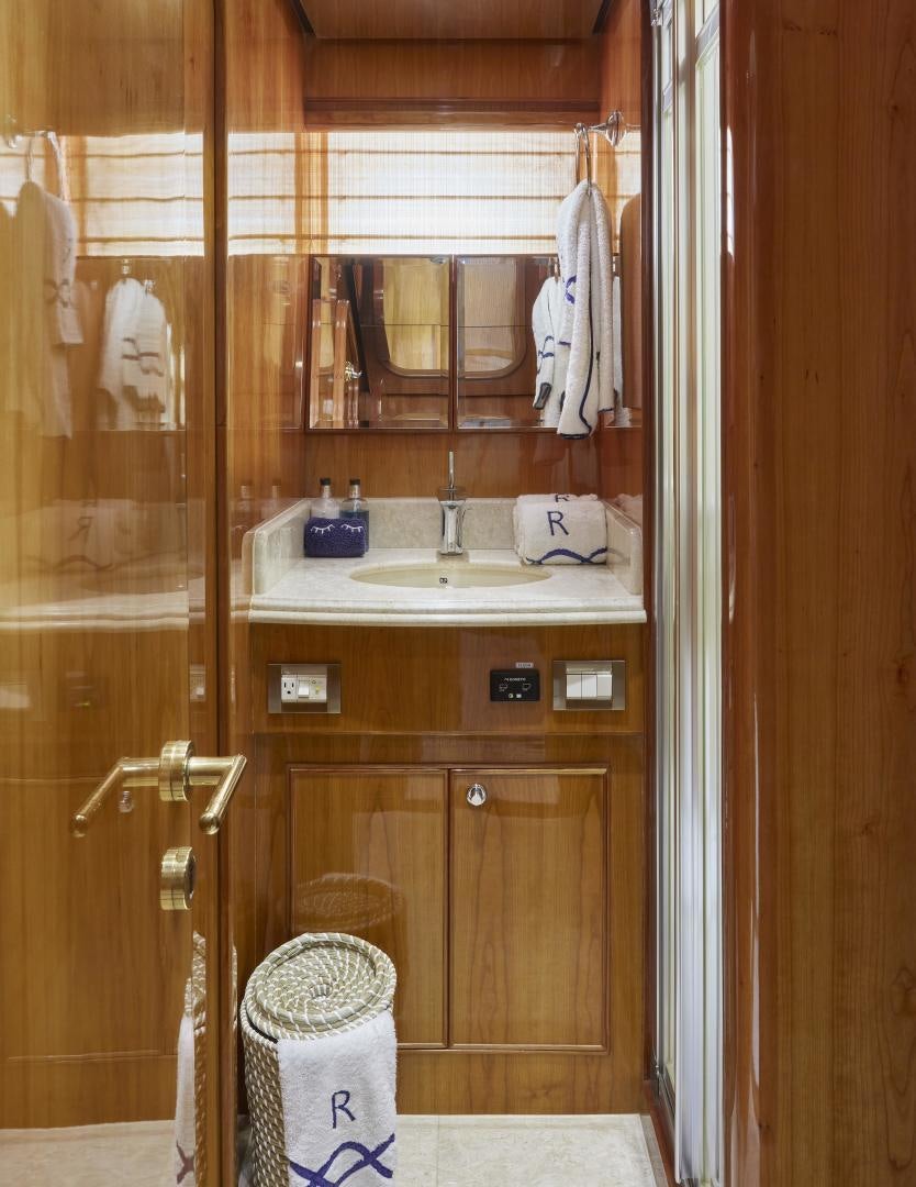 a bathroom with a sink and mirror aboard GRACE Yacht for Sale