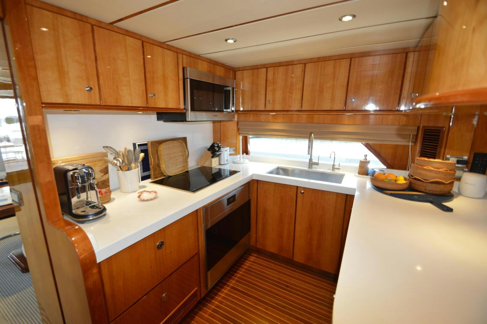 a kitchen with wooden cabinets aboard GRACE Yacht for Sale