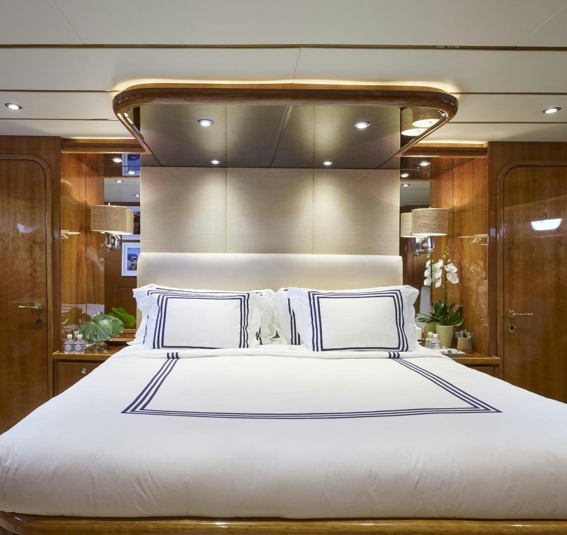 a bed with white sheets aboard GRACE Yacht for Sale