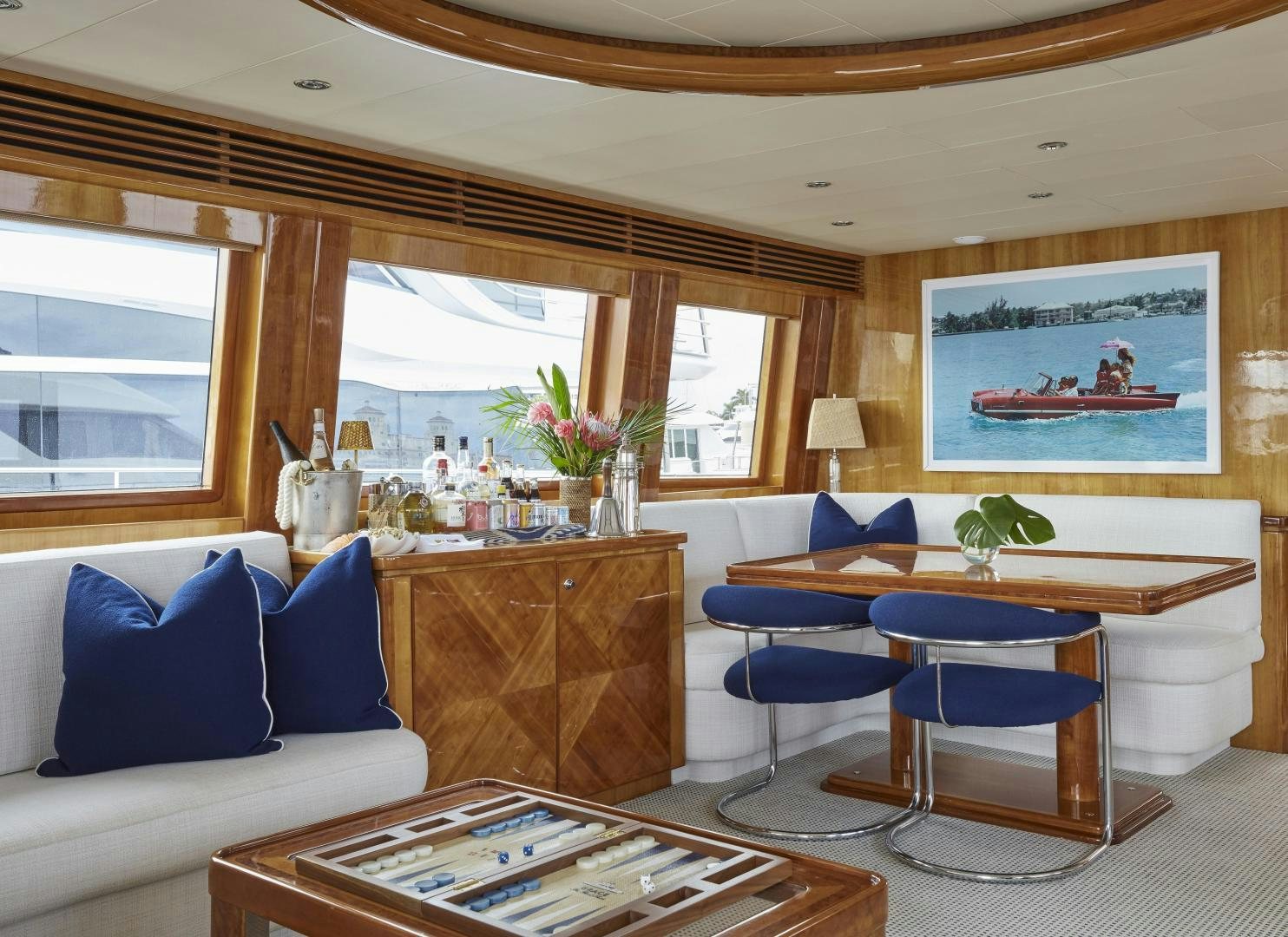 a living room with a blue couch and a wood table aboard GRACE Yacht for Sale