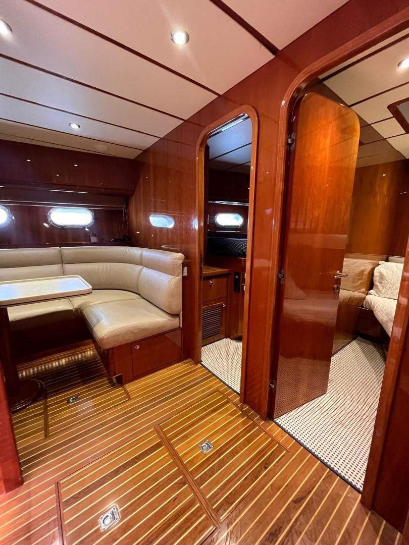 a room with a couch and a wood door aboard GRACE Yacht for Sale