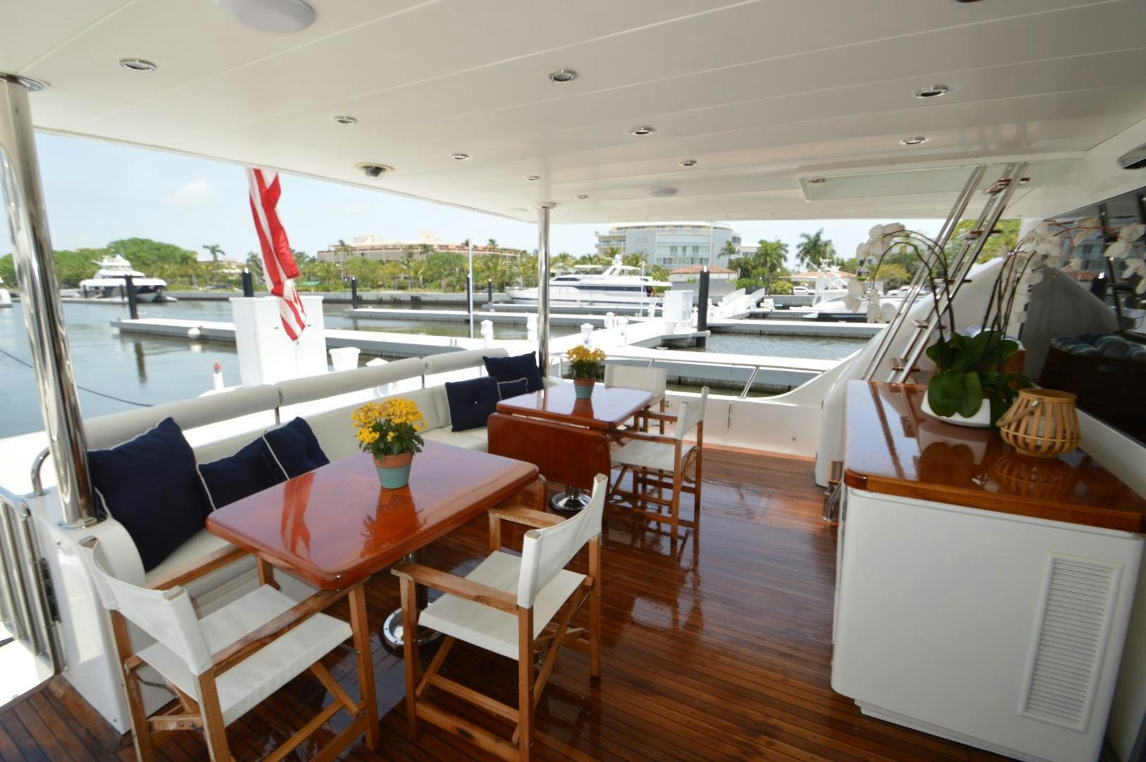 a room with a table chairs and plants in it aboard GRACE Yacht for Sale