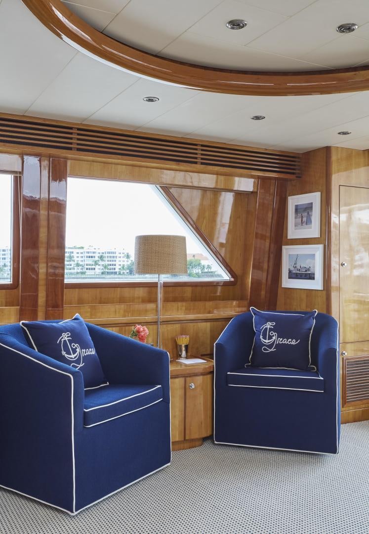 a room with blue couches aboard GRACE Yacht for Sale