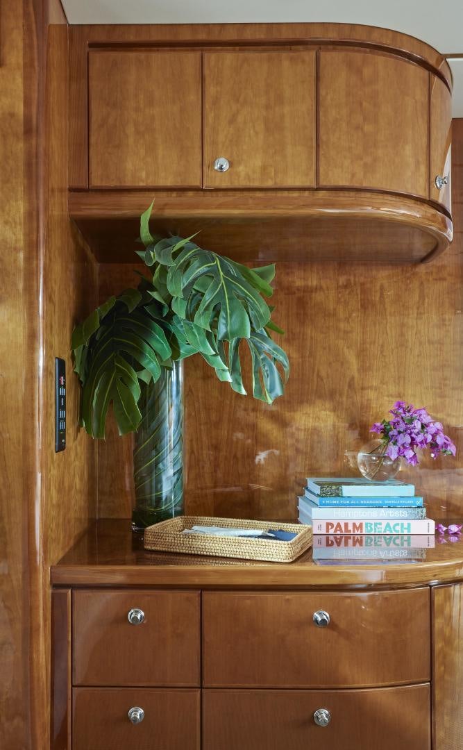 a vase with books and a plant on a shelf aboard GRACE Yacht for Sale