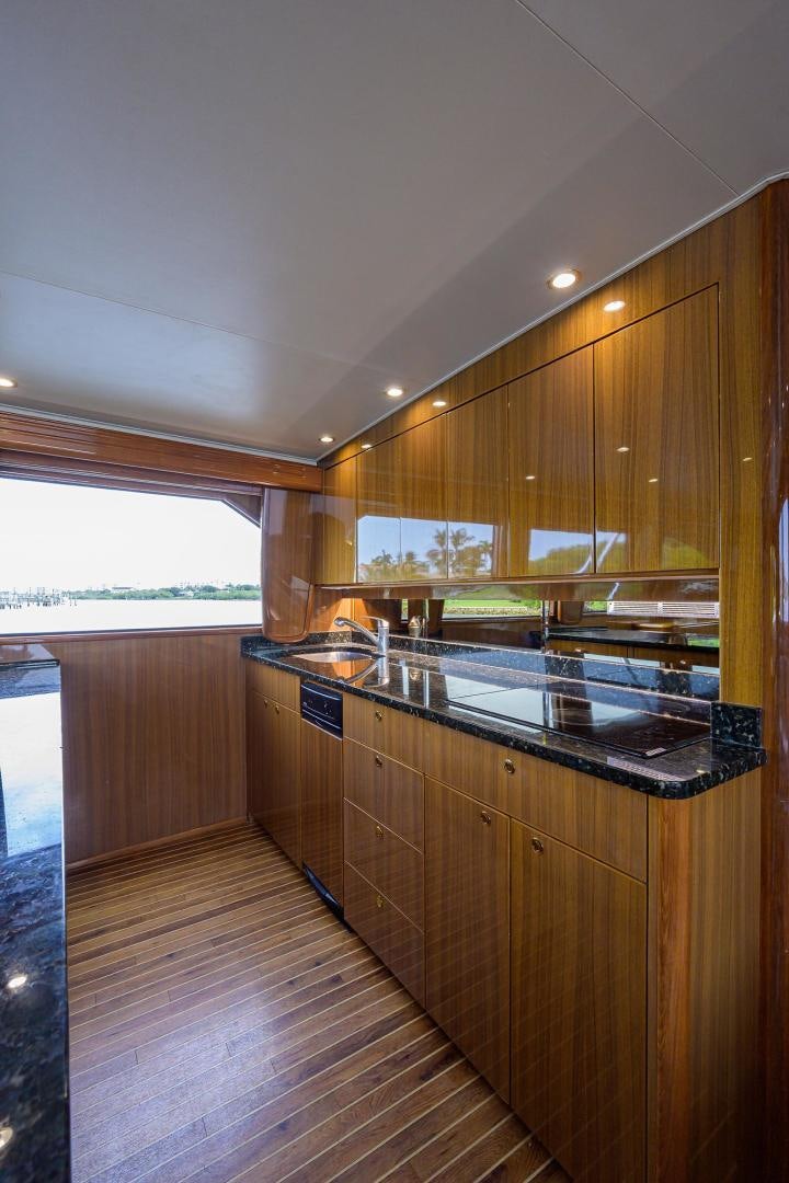 a kitchen with wooden cabinets aboard LA LADY Yacht for Sale