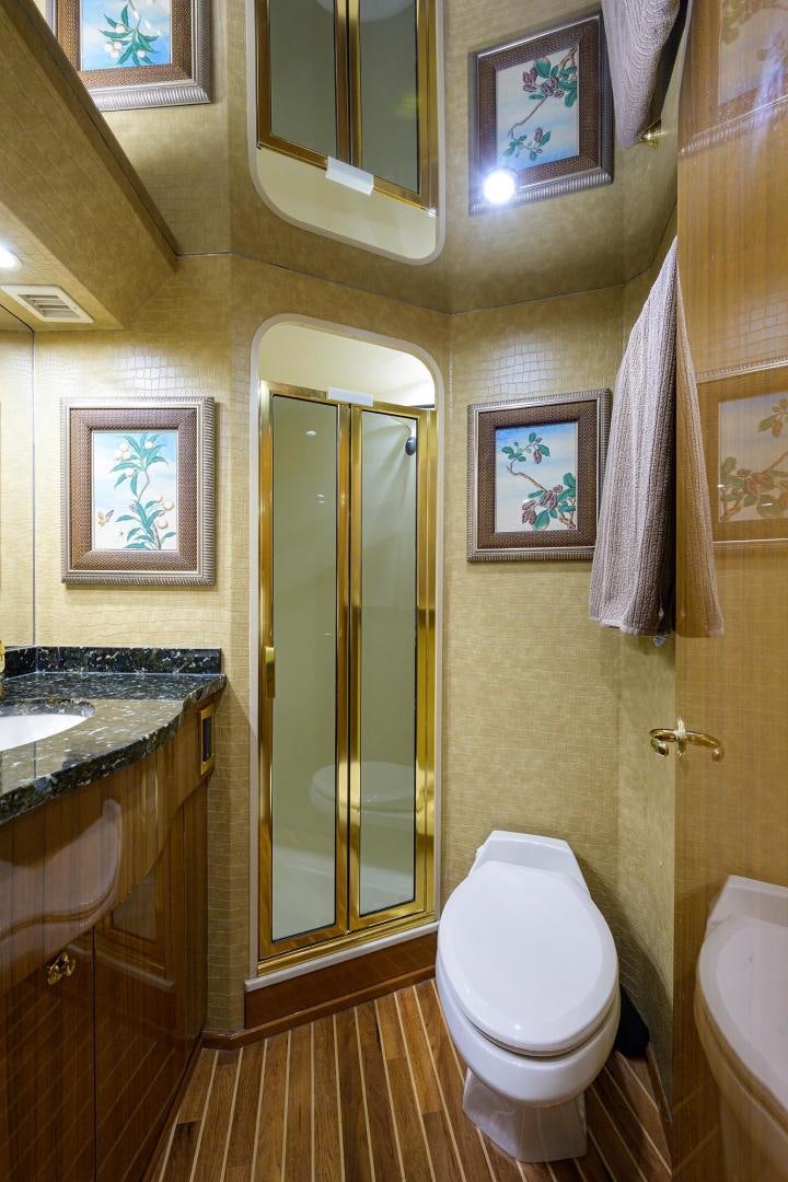a bathroom with a toilet and sink aboard LA LADY Yacht for Sale