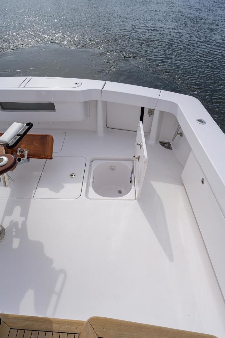 a white boat with a wooden dock aboard LA LADY Yacht for Sale