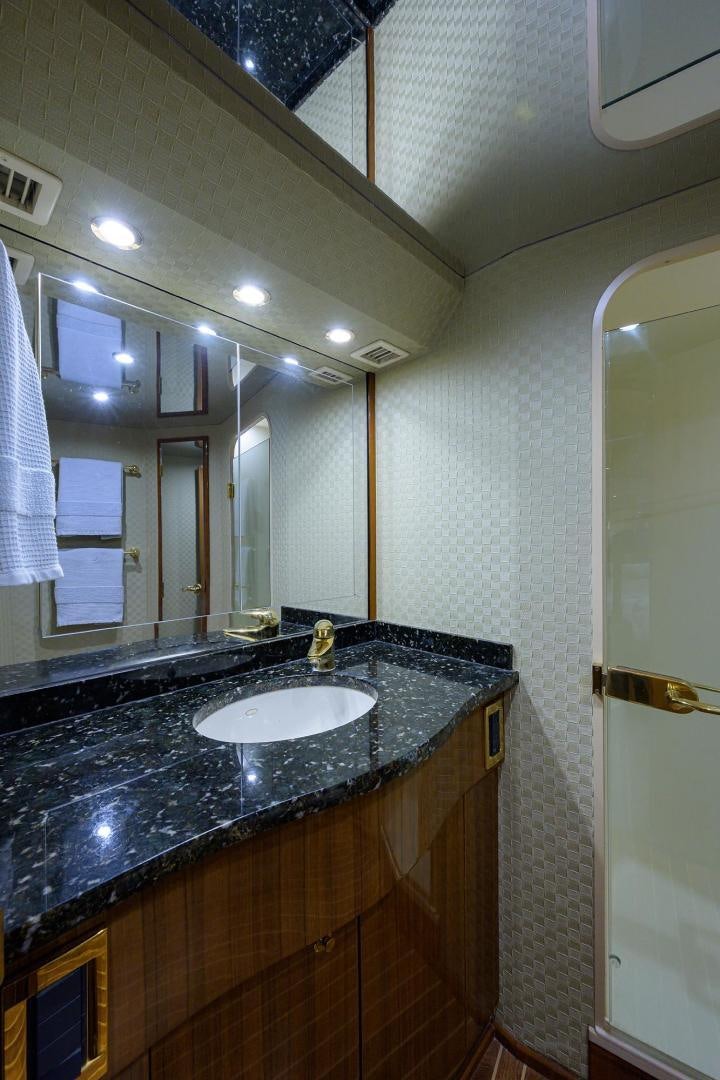 a bathroom with a sink and mirror aboard LA LADY Yacht for Sale