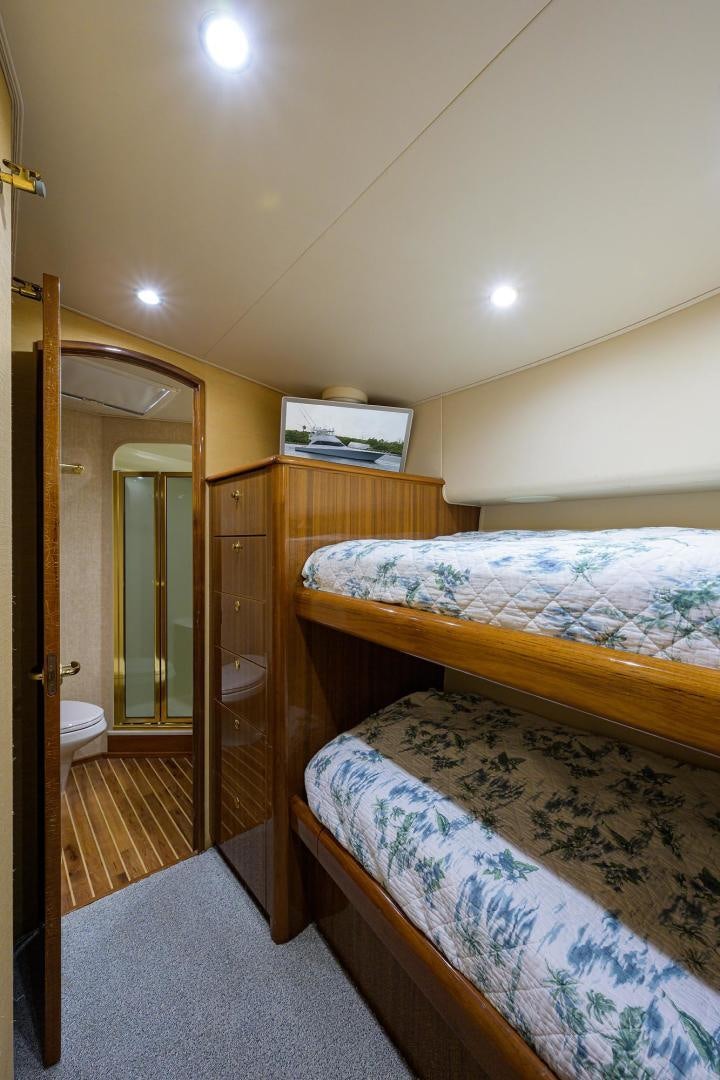 a bedroom with a bed and a closet aboard LA LADY Yacht for Sale