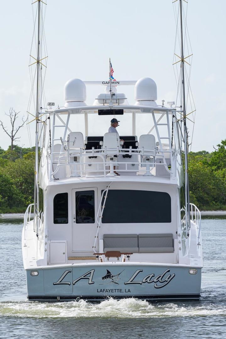 a white boat with a person on it aboard LA LADY Yacht for Sale