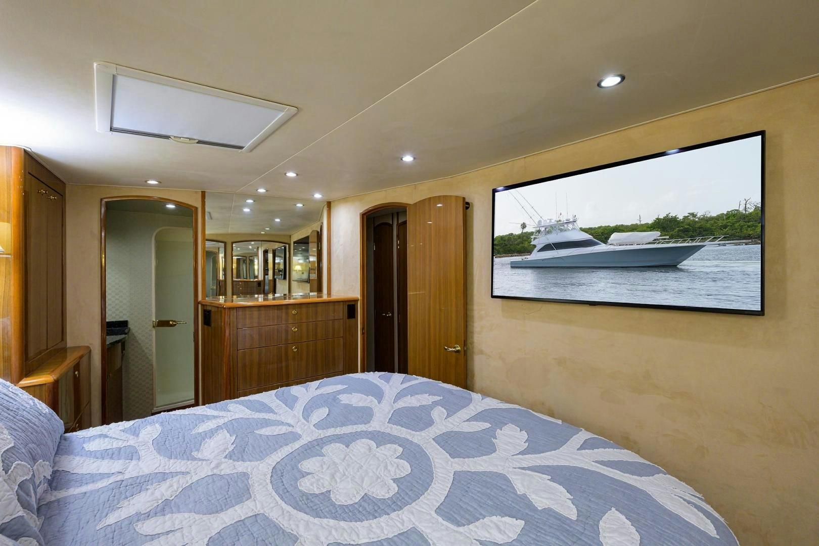 a bedroom with a large bed aboard LA LADY Yacht for Sale