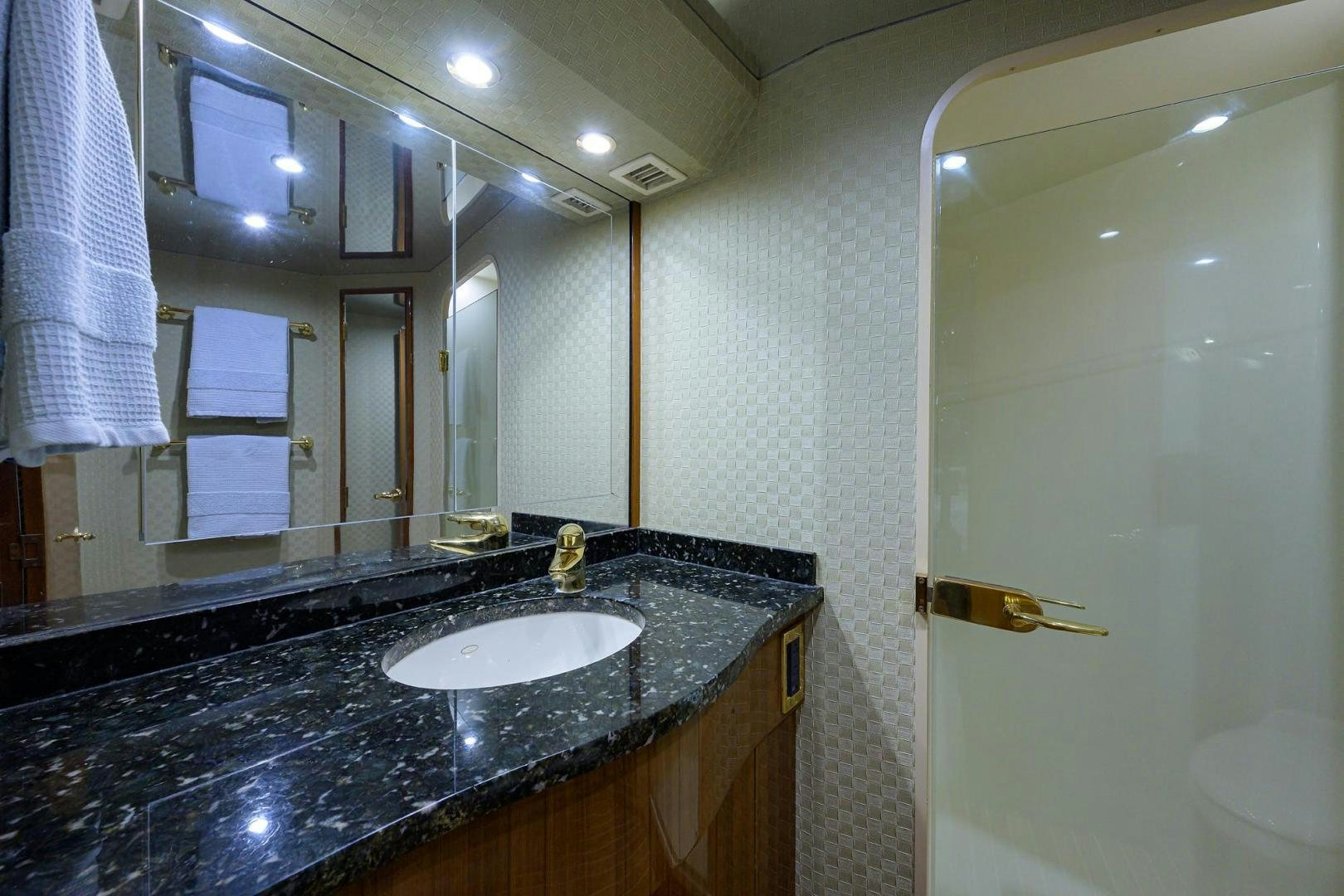 a bathroom with a sink and a mirror aboard LA LADY Yacht for Sale