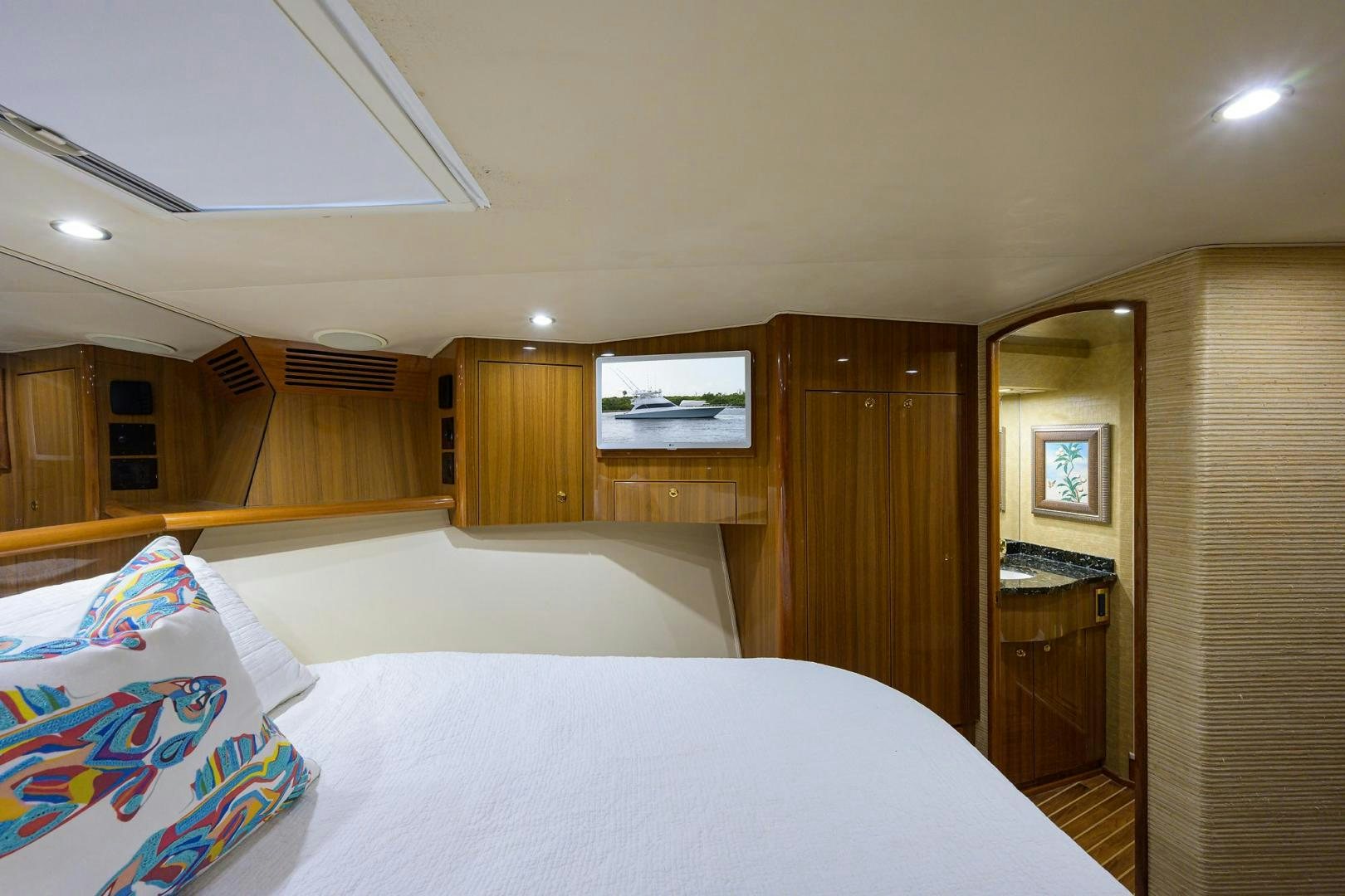 a room with a bed and a television aboard LA LADY Yacht for Sale