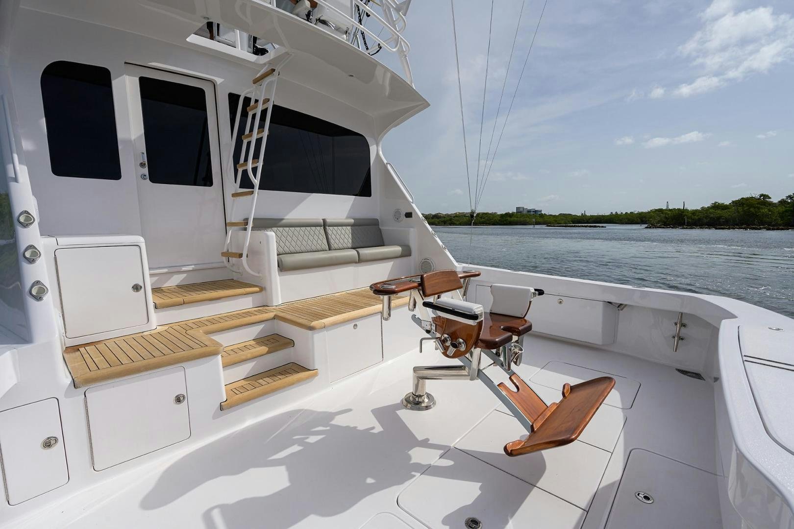a boat with a deck and chairs aboard LA LADY Yacht for Sale
