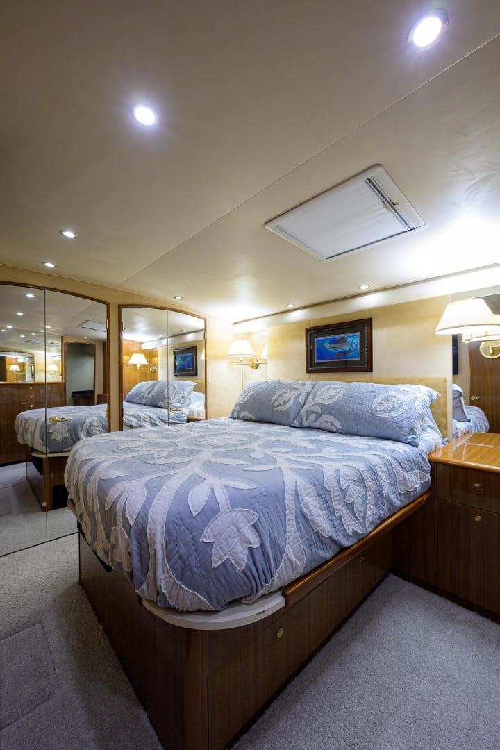a bedroom with two beds aboard LA LADY Yacht for Sale