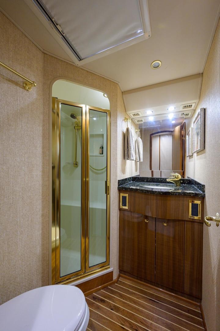 a bathroom with a glass shower door aboard LA LADY Yacht for Sale
