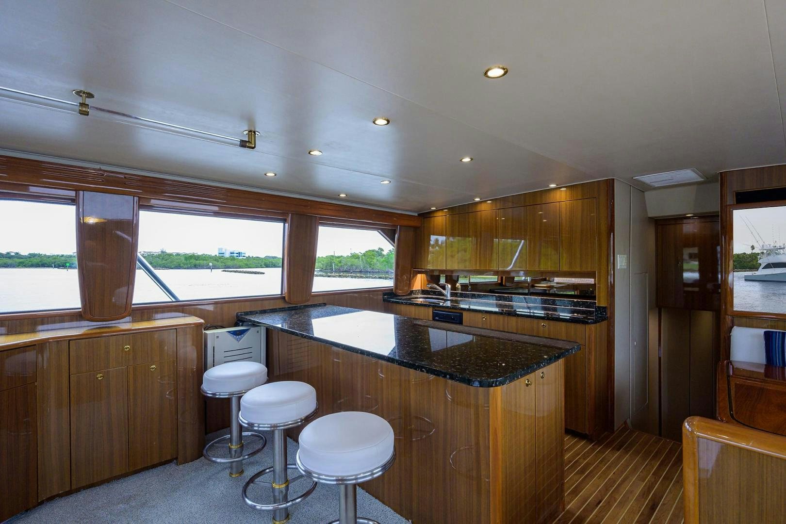 a kitchen with a bar and stools aboard LA LADY Yacht for Sale