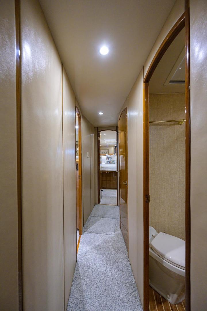 a bathroom with a toilet and a hallway aboard LA LADY Yacht for Sale