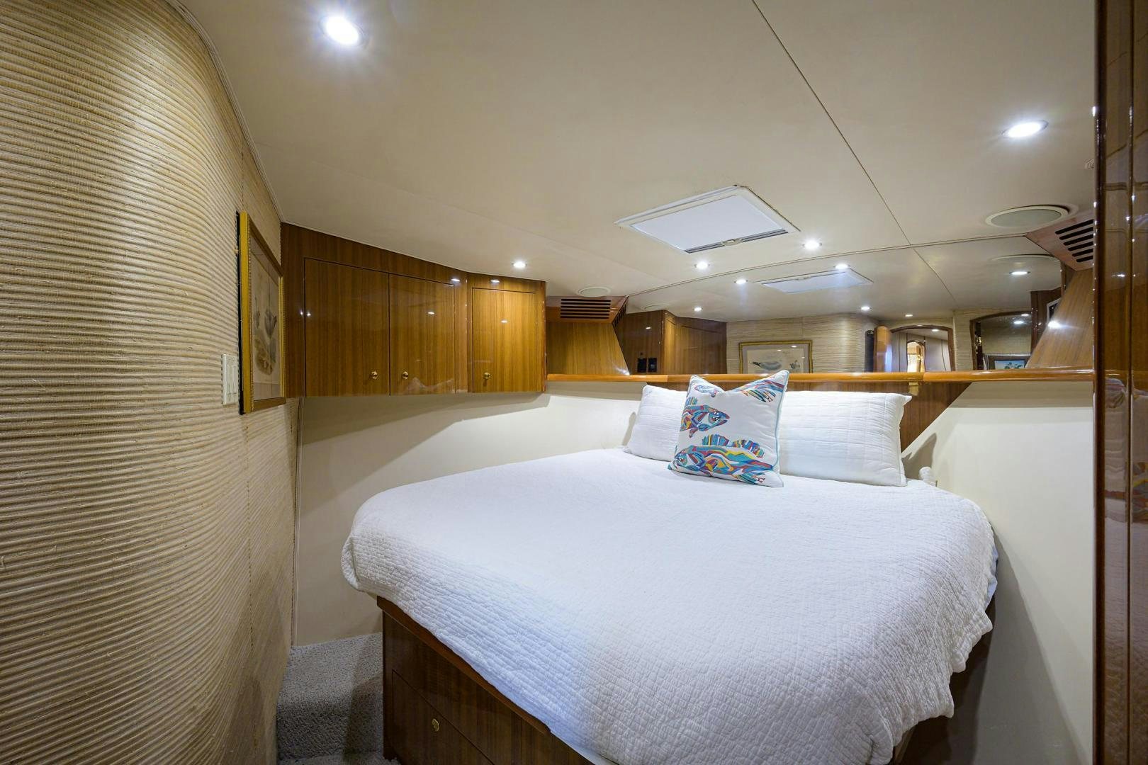 a room with a bed and a wood cabinet aboard LA LADY Yacht for Sale