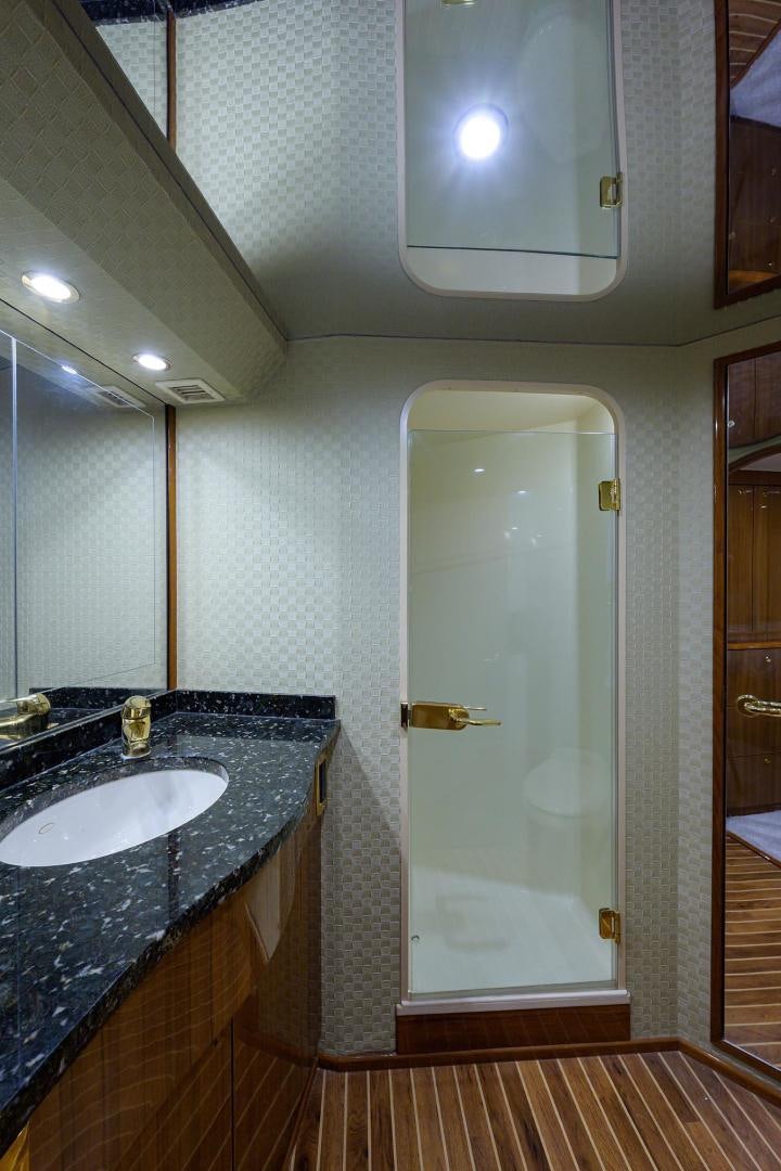 a bathroom with a sink and a door aboard LA LADY Yacht for Sale