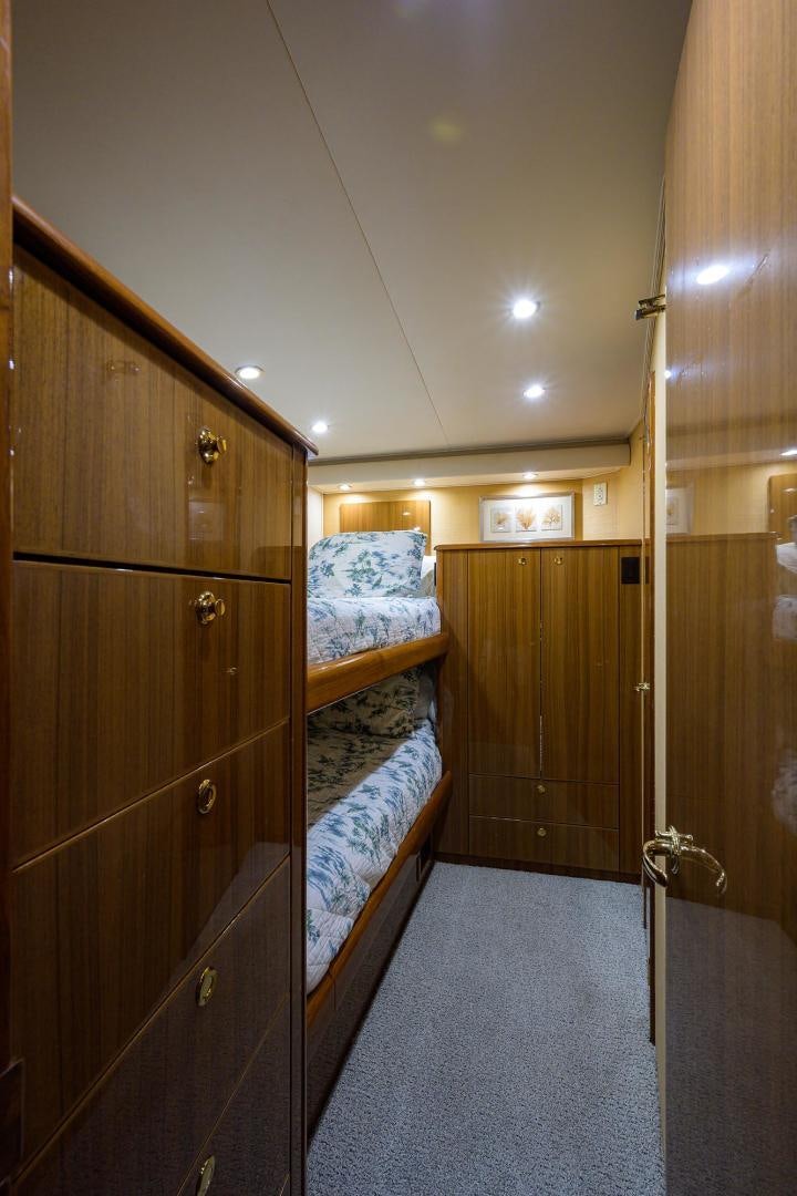 a bedroom with wood cabinets aboard LA LADY Yacht for Sale