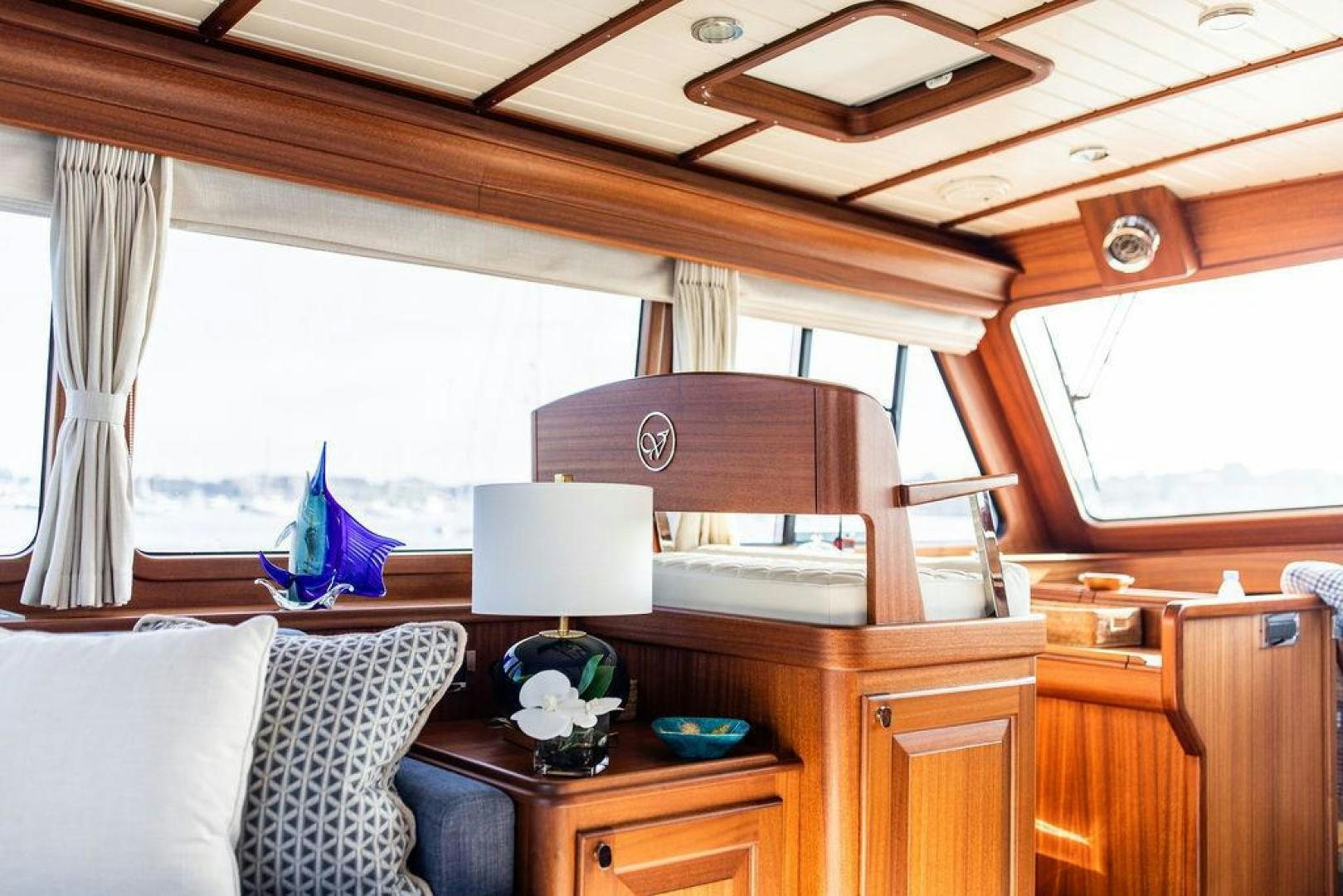 a room with a table and a bed aboard JESSICA Yacht for Sale