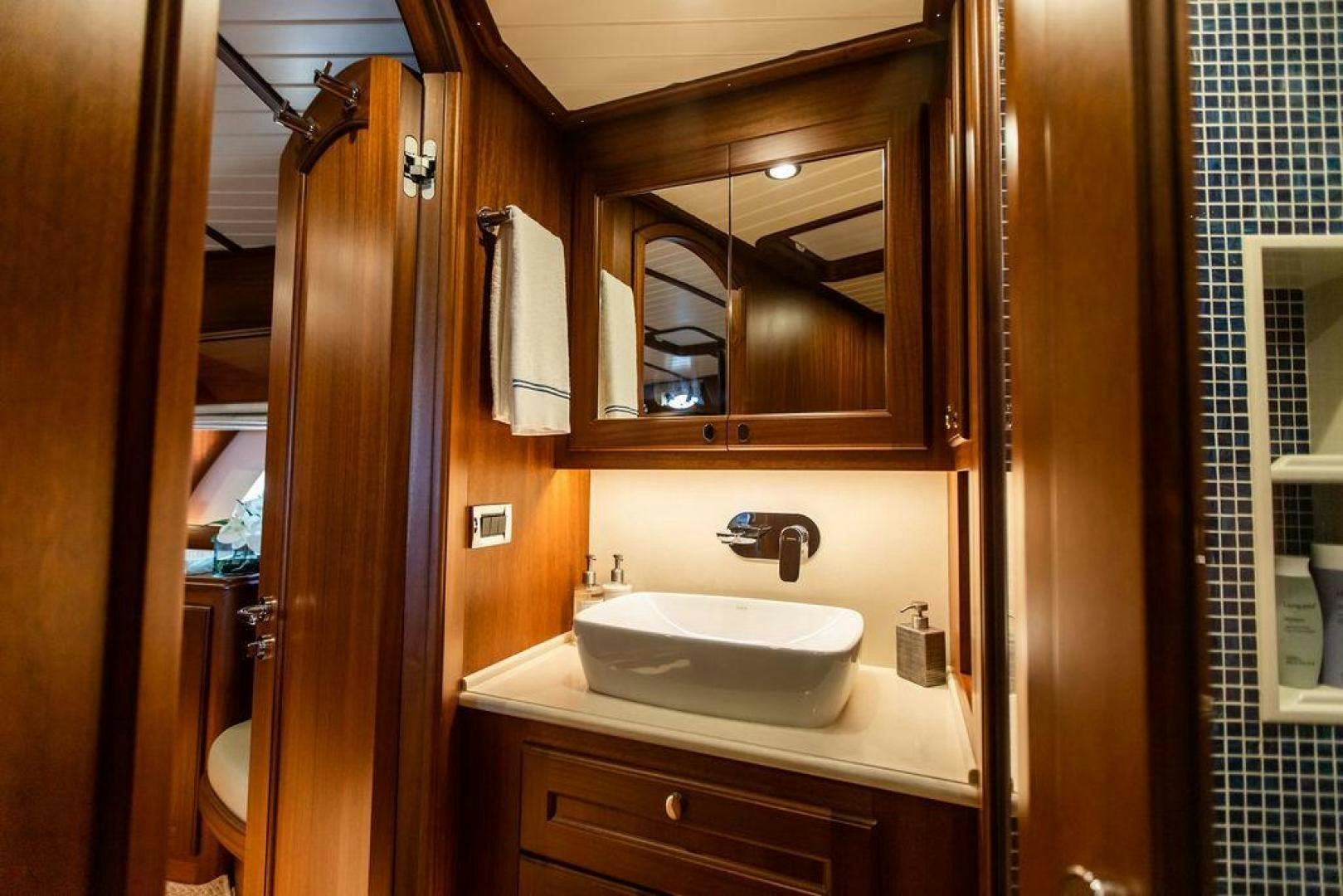 a bathroom with a sink and a mirror aboard JESSICA Yacht for Sale